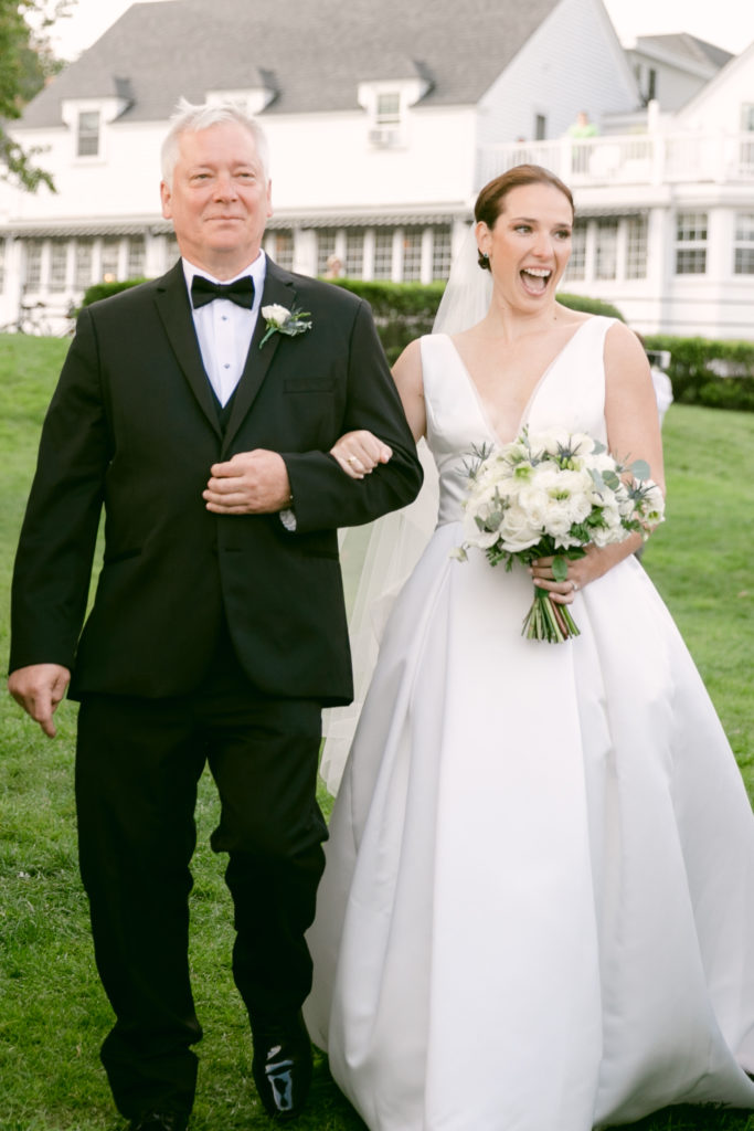 bride walking down the aisle with her father for outdoor summer Maine wedding