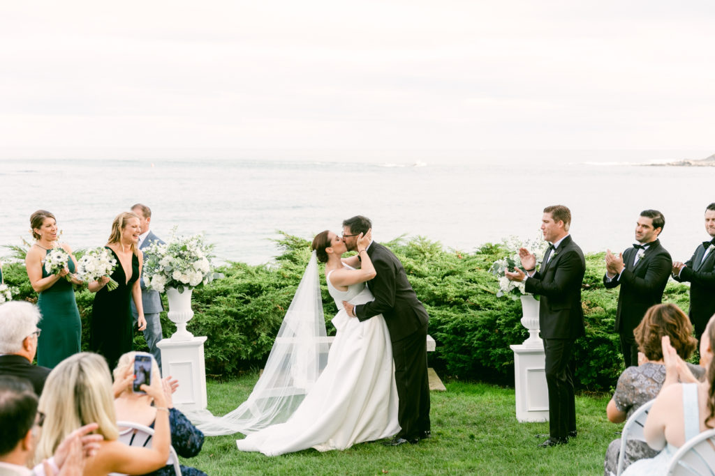 bride and groom first kiss for coastal wedding