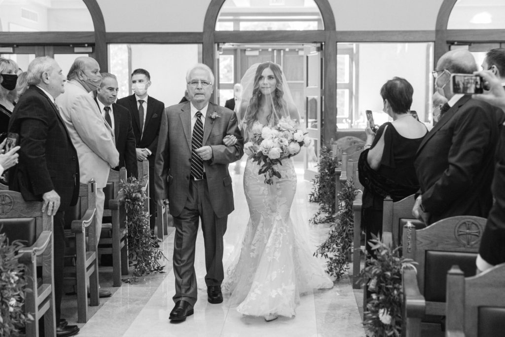 bride walking down the aisle in greek orthodox church