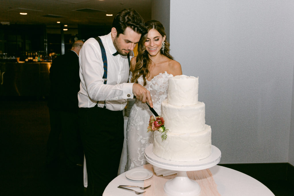 Boston State Room Luxury Wedding reception cutting the cake
